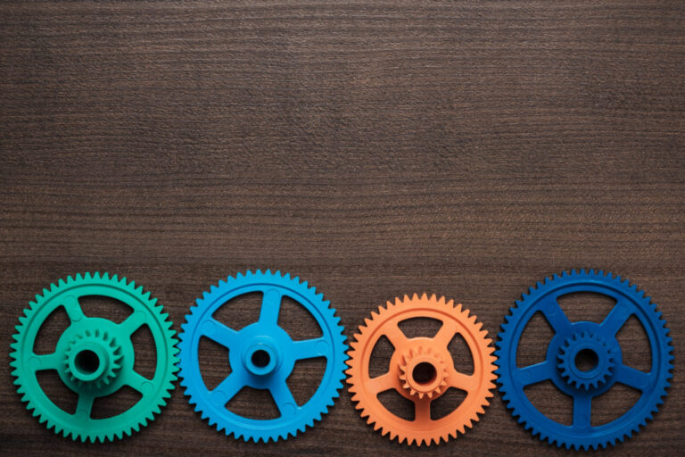 colorful gears on the wooden background