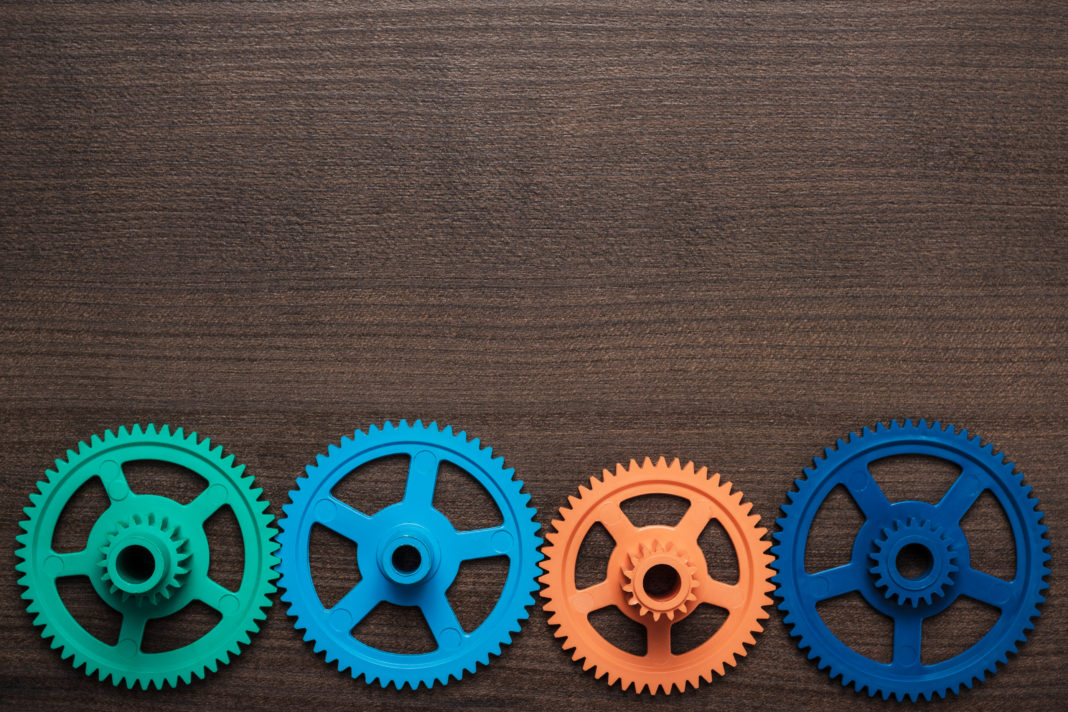 colorful gears on the wooden background