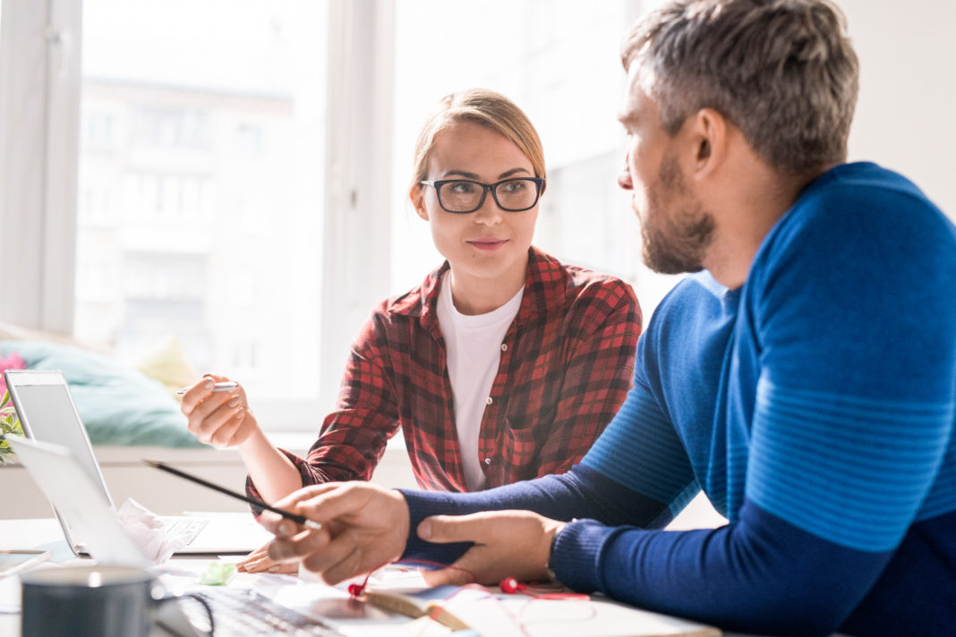 content female coding specialist explaining idea of new app