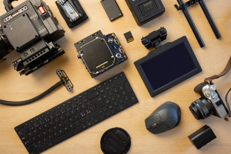 flat lay of filming equipment with computer parts on table
